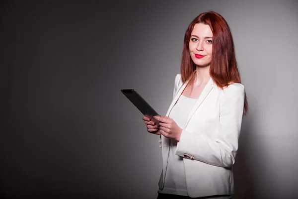 Red businesswoman holding tablet and showing thumbs up isolated over white