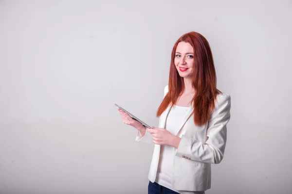 Red businesswoman holding tablet and showing thumbs up isolated over white