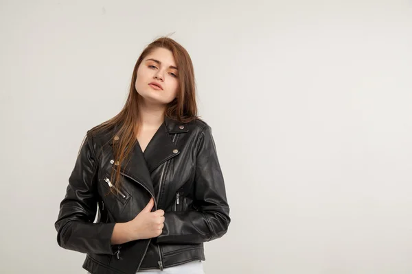 Glamorous woman in black leather jacket isolated on white background
