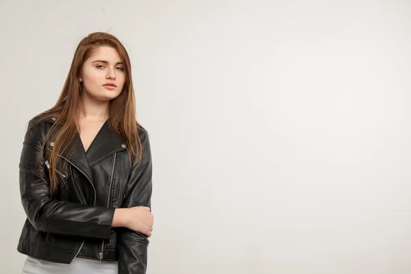 Glamorous woman in black leather jacket isolated on white background