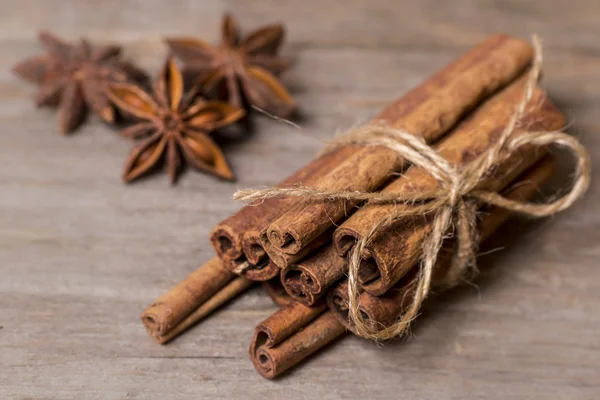 Cinnamon sticks close up on wooden background