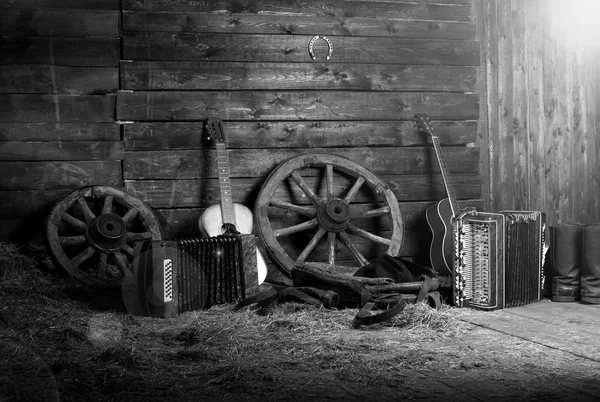 Old shed in the morning at sunrise. Musical instruments in the hayloft. Guitar and harmonica