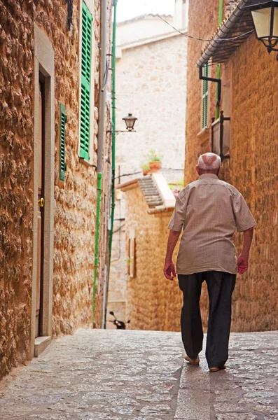 Mallorca, Balearic islands, Spain: an old man walks in a street in Fornalutx