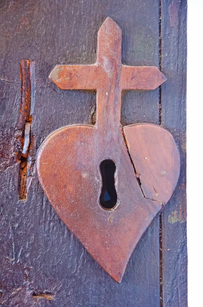 The lock in the shape of heart and cross