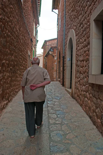 Mallorca, Balearic islands, Spain: an old man walks in a street in Fornalutx