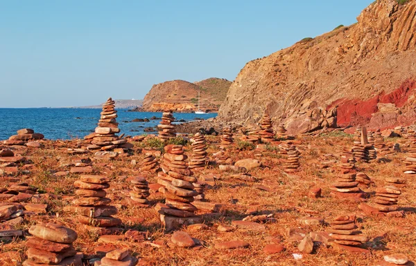 Menorca, Balearic Islands, Spain: rock castles and red sand on the path to Cala Pregonda beach
