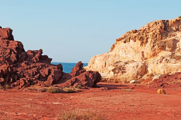 Menorca, Balearic Islands, Spain: the red sand and rocks on the path to Cala Pregonda beach