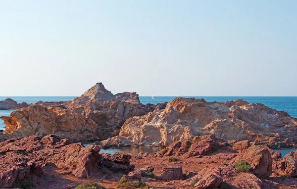 Menorca, Balearic Islands, Spain: the red sand and rocks on the path to Cala Pregonda beach