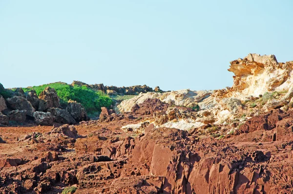 Menorca, Balearic Islands, Spain: the red rocks on the path to Cala Pregonda beach