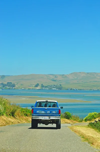 California, Usa: a van and the view of the inlet of Bodega Bay