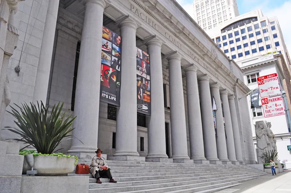 San Francisco, California, Usa: a man seated on the stairs of Pacific Stock Exchange building