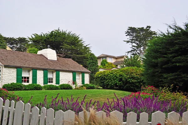 Carmel: a wooden fence, a garden and a house
