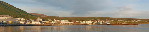 Iceland: panoramic view of the harbour and the city of Husavik at sunset