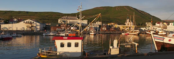 Iceland: view of the harbour and the city of Husavik at sunset