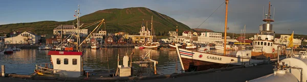 Iceland: view of the harbour and the city of Husavik at sunset
