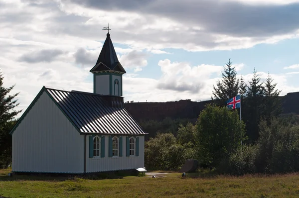 Iceland: Icelandic flag and the Thingvellir church