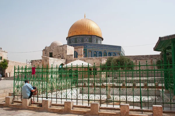 Jerusalem, Israel: a muslim washing his feet in front of the Dome of the Rock