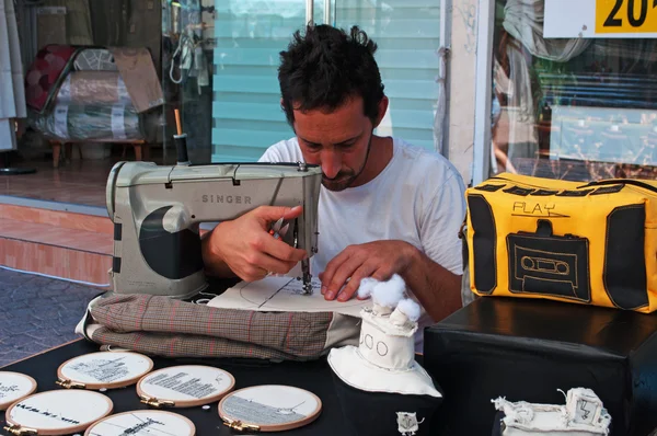 Tel Aviv: a tailor at Nachalat Binyamin Market
