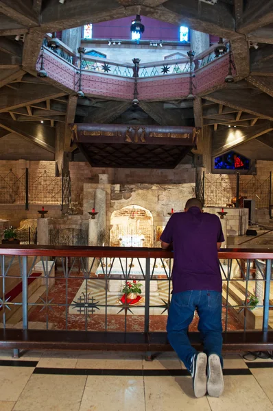 Nazareth: a man prays in the lower level of the Church of the Annunciation