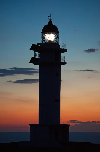 Fomentera: Cap de Barbaria Lighthouse with the light on at sunset