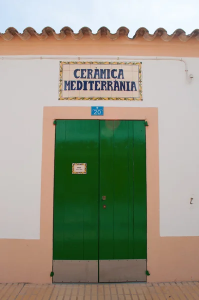 Formentera: the green door of Ceramica Mediterranea, a ceramic craft store in Sant Francesc Xavier