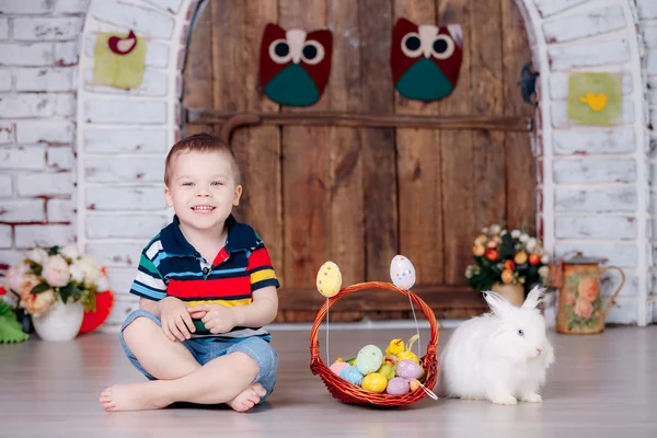 Happy boy with rabbit and easter eggs