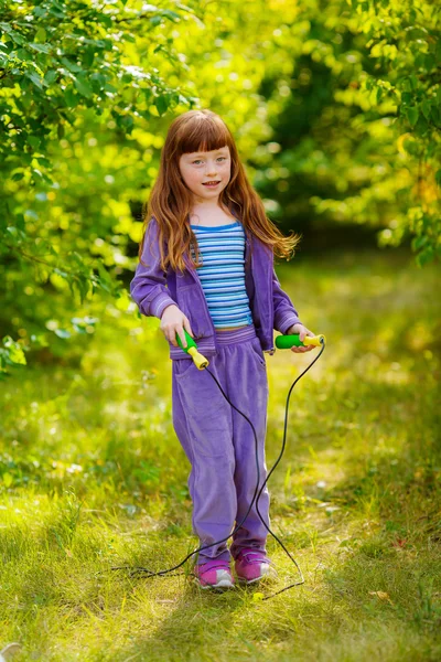 Little girl jumping on a skipping rope