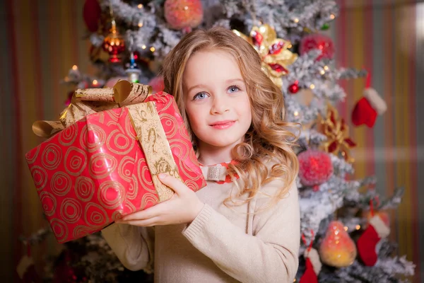 Little girl near the Christmas tree.