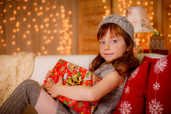 Happy little girl holding gift