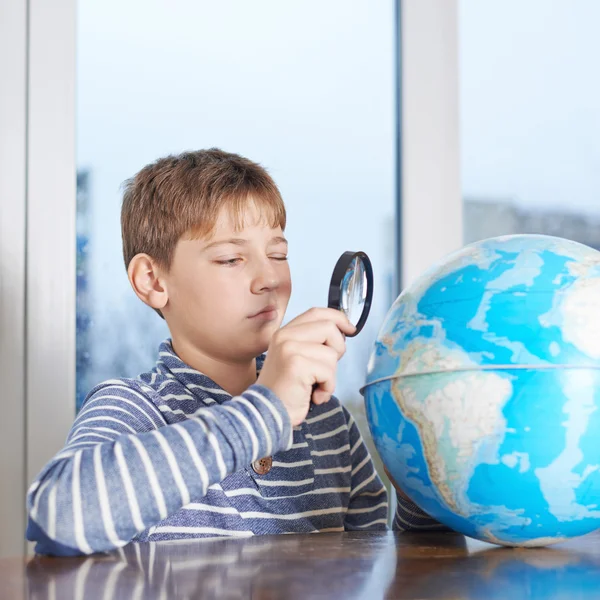 Boy looking at the earth globe