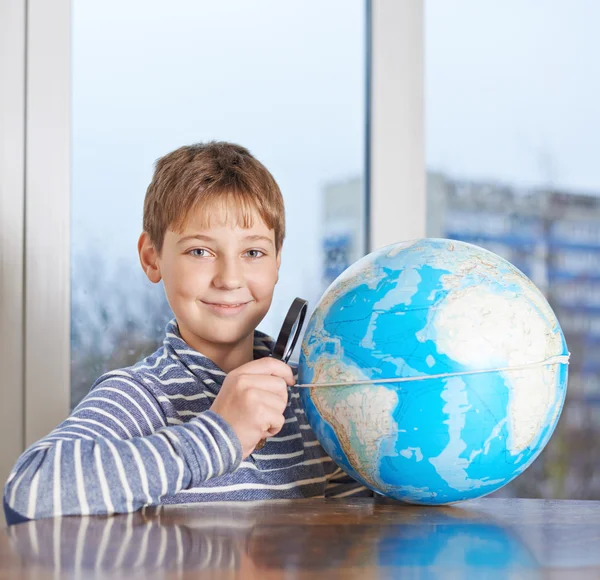 Boy looking at the earth globe