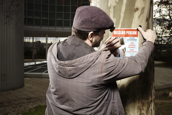 Taping poster of missing person