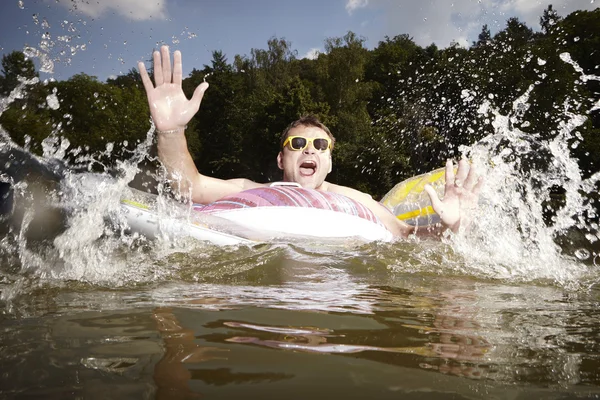 Waves on lake - man with inflatable ring