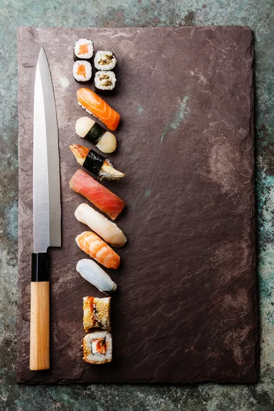 Sushi rolls and nigiri with Japanese knife