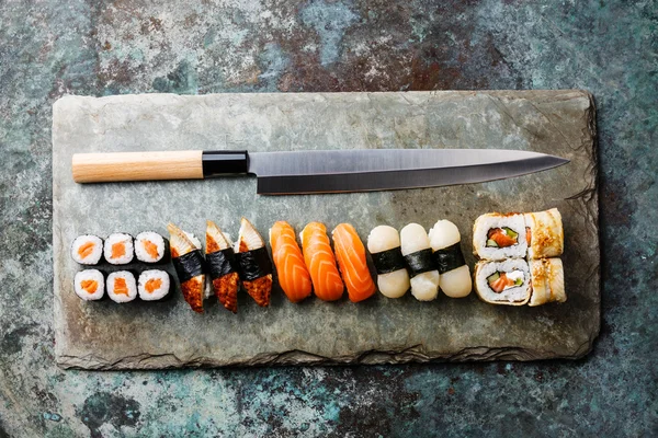 Sushi rolls and nigiri with Japanese knife