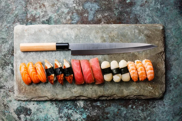 Sushi rolls and nigiri with Japanese knife