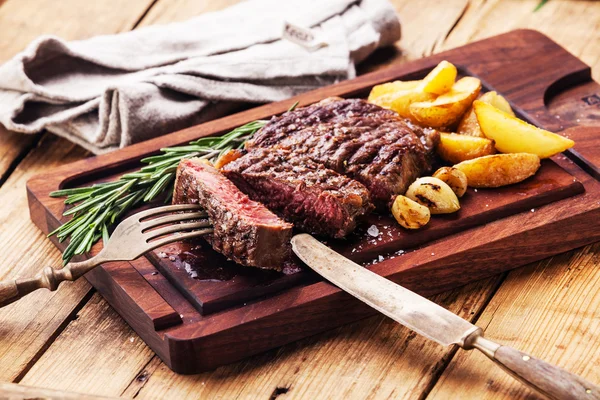 Sliced medium rare grilled Beef steak Ribeye with roasted potato