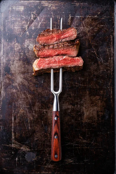 Beef steak on fork