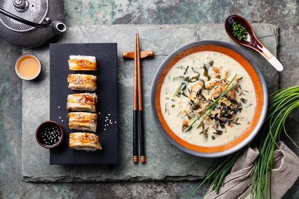 Creamy soup with Eel and sushi rolls