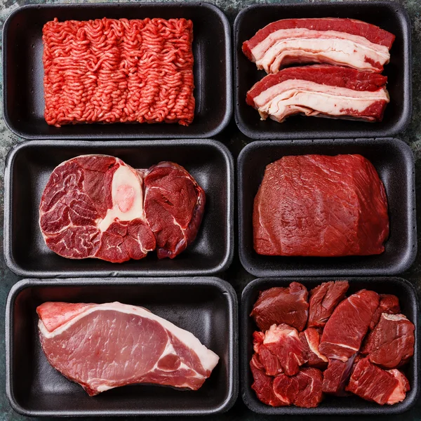 Different types of meat in plastic boxes