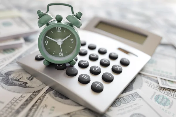Calculator and alarm clock on money