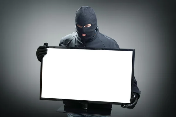 Thief stealing computer monitor