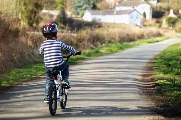 Boy learning to ride his bike