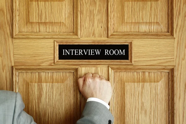 Businessman knocking on interview room
