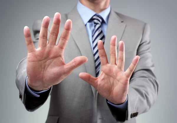 Stop or fear gesture from businessman