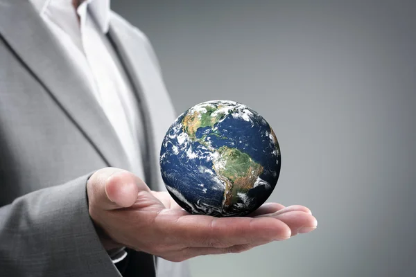 Businessman holding the world in his hands