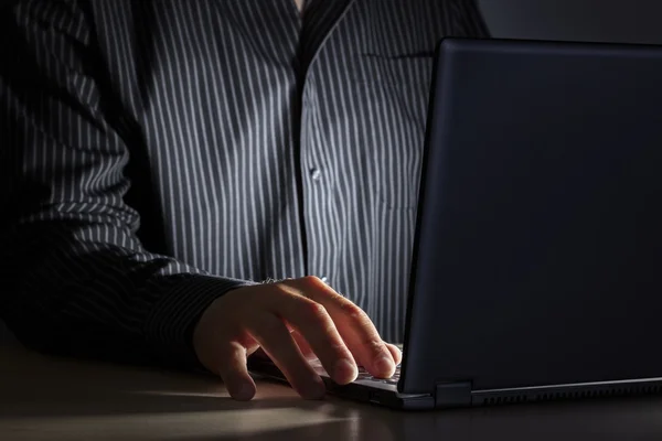Man using laptop at a desk