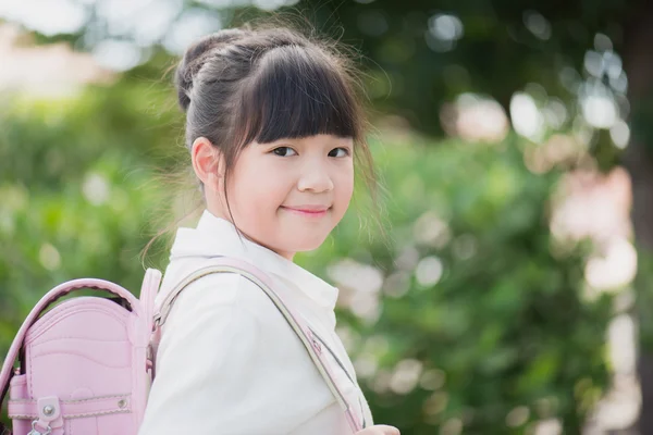 Asian school girl with pink backpack