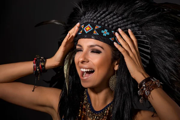 Portrait of screaming  woman in costume of  American Indian
