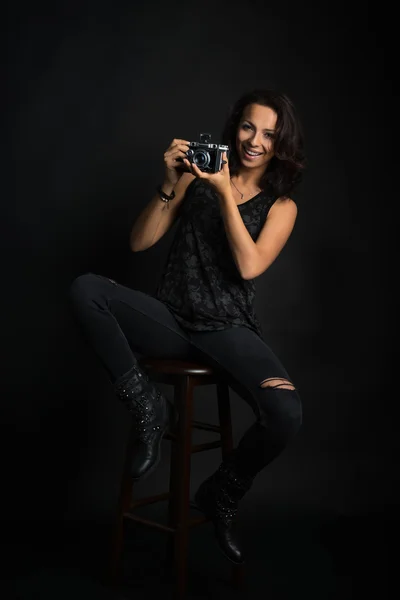 Brunette woman holding  vintage camera